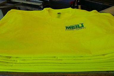 A stack of completed screen-printed shirts